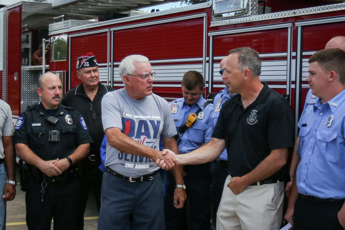 In this file photo, Sam Baker, Chairman and CEO of First Financial Bank Conroe Region, shakes hands with Conroe Fire Lt. Lloyd Sandefer, Conroe Professional Firefighters Association President, at the conclusion of an appreciation lunch for first responders on Monday, Oct. 9, 2017, at Conroe VFW Post 4709.