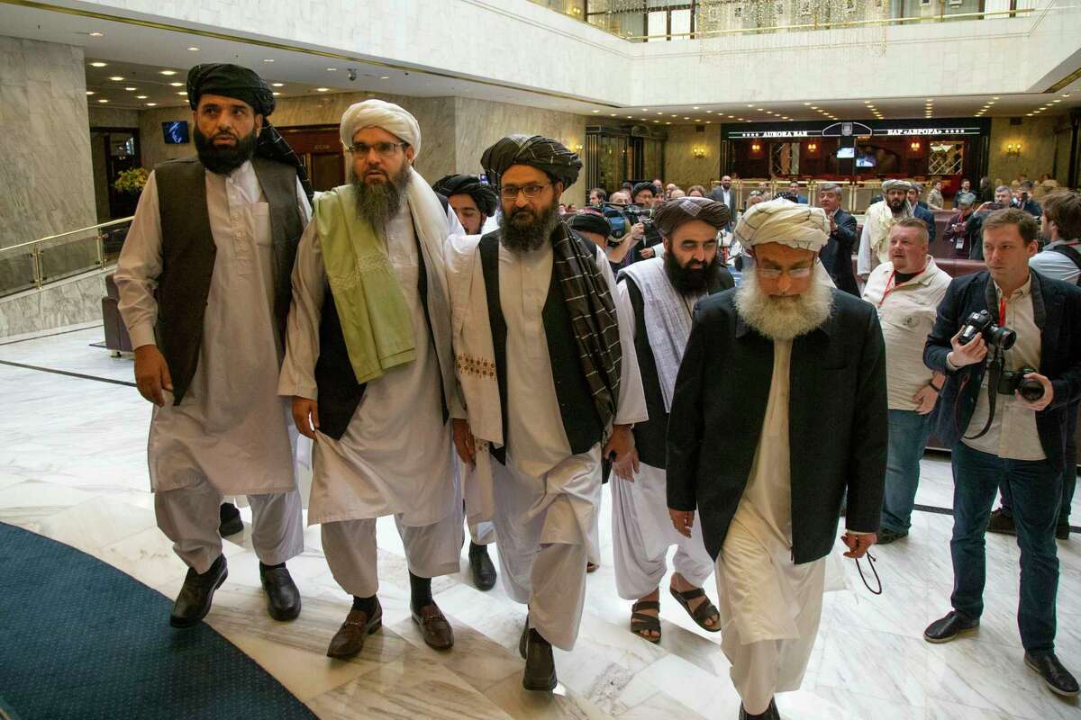 FILE - In this May 28, 2019, file photo, Mullah Abdul Ghani Baradar, the Taliban group's top political leader, third from left, arrives with other members of the Taliban delegation for talks in Moscow, Russia. America began bombing Afghanistan after 9/11 to root out al-Qaida fighters, who were being harbored by the Taliban. Nearly 19 years later, the Trump administrationas negotiator Zalmay Khalilzad says heas satisfied with the militant groupas pledge to keep terror groups from using Afghanistan as a launch pad for attacks against the West.(AP Photo/Alexander Zemlianichenko, File)