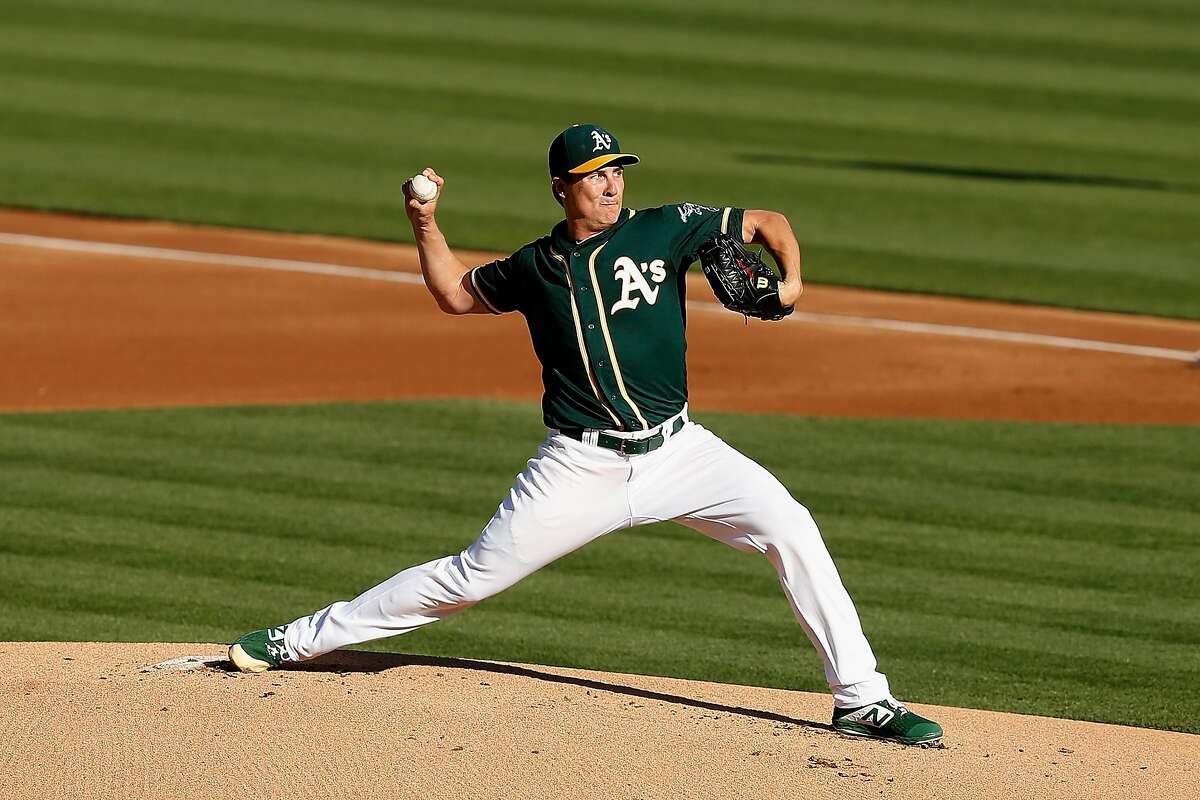 OAKLAND, CALIFORNIA - JULY 27: Homer Bailey #15 of the Oakland Athletics pitches in the top of the first inning against the Texas Rangers at Ring Central Coliseum on July 27, 2019 in Oakland, California. (Photo by Lachlan Cunningham/Getty Images)