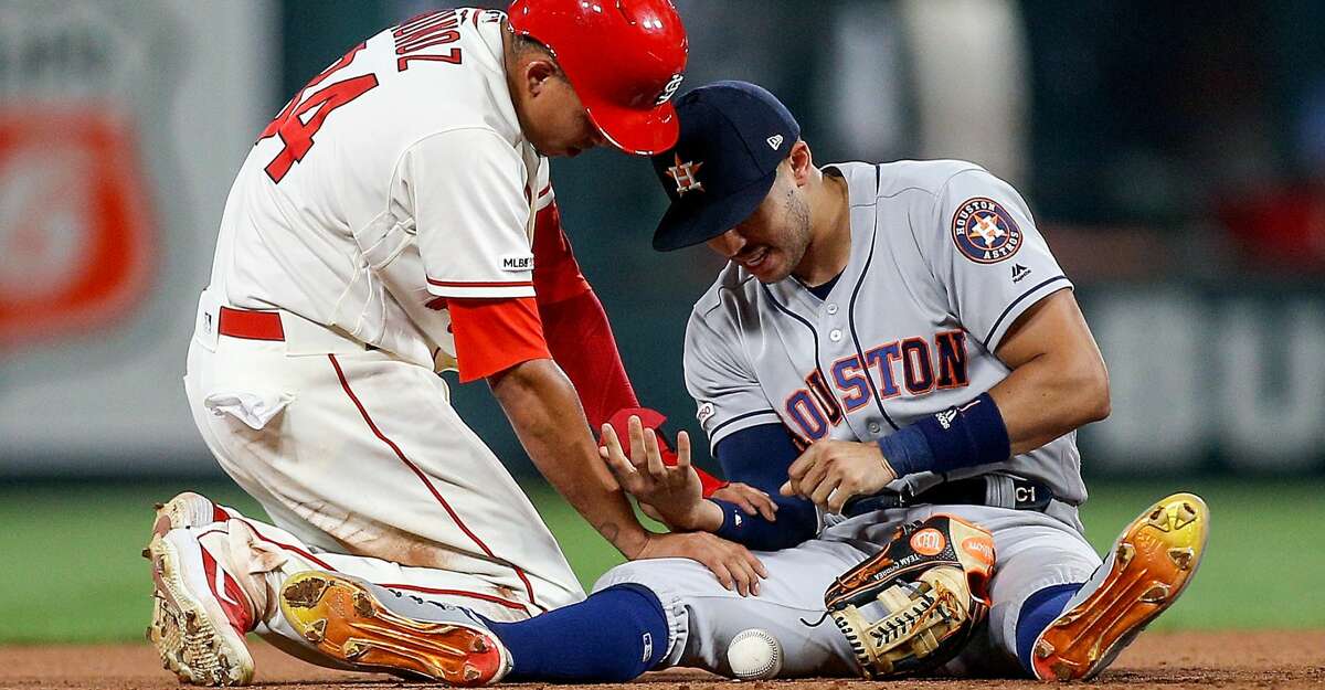 ST. LOUIS, MO - JULY 27: Yairo Munoz #34 of the St. Louis Cardinals checks on Carlos Correa #1 of the Houston Astros as Correa injured his arm while making an out against Munoz during the eighth inning at Busch Stadium on July 27, 2019 in St. Louis, Missouri. (Photo by Scott Kane/Getty Images)