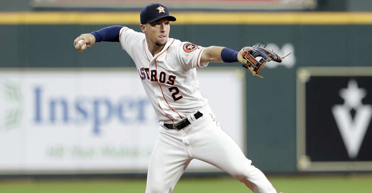 Alex Bregman catches the ball after it bounces off
