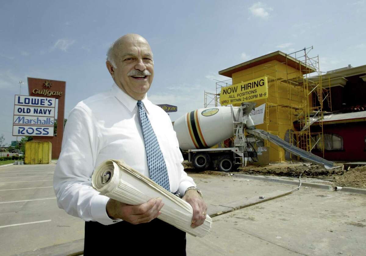 Shopping center developer and civic leader Ed Wulfe poses by a new Doneraki restaurant in this April 18, 2003 file photo.