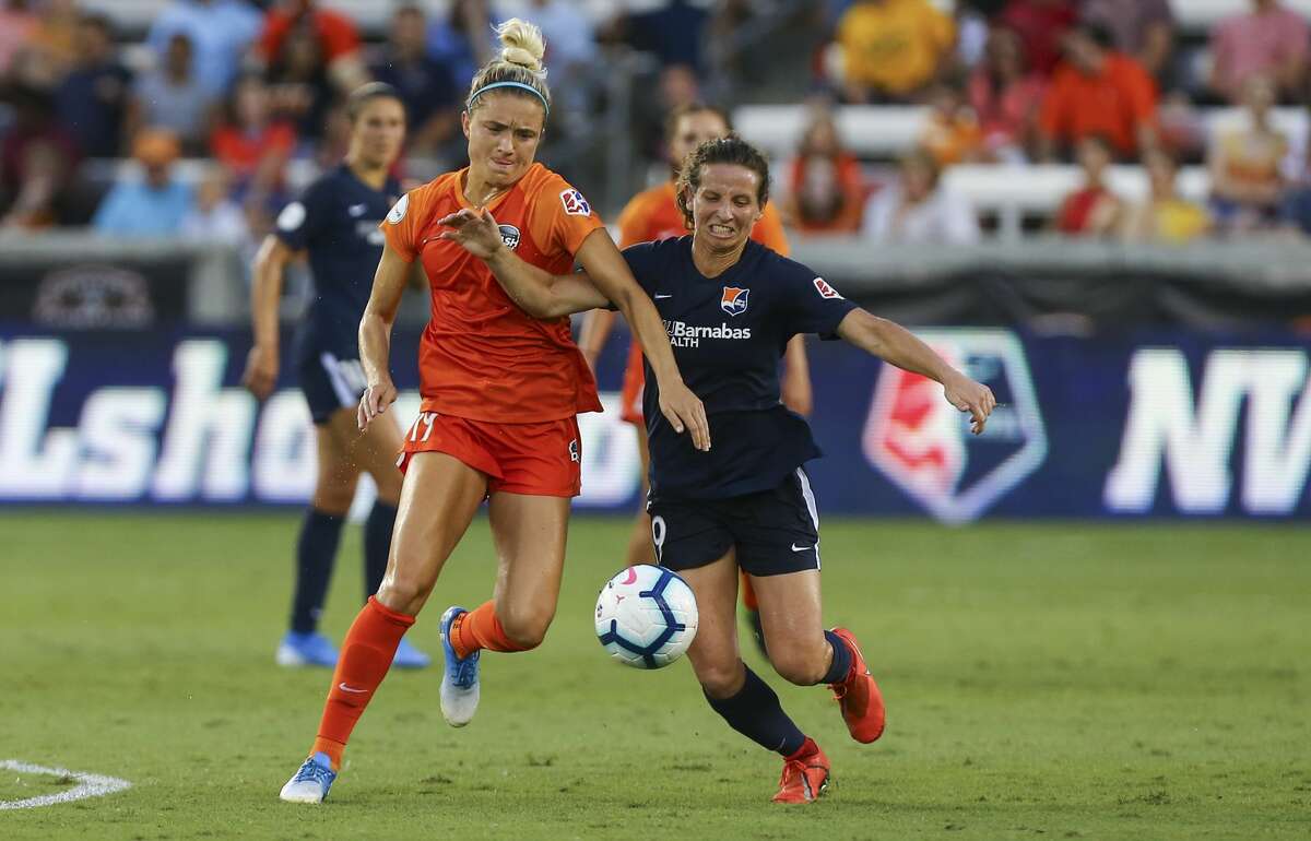 Houston Dash midfielder Kristie Mewis (19) and Sky Blue FC midfielder Elizabeth Eddy (19) battle for control of the ball during the first half of an NWSL match at BBVA Stadium Sunday, July 28, 2019, in Houston.