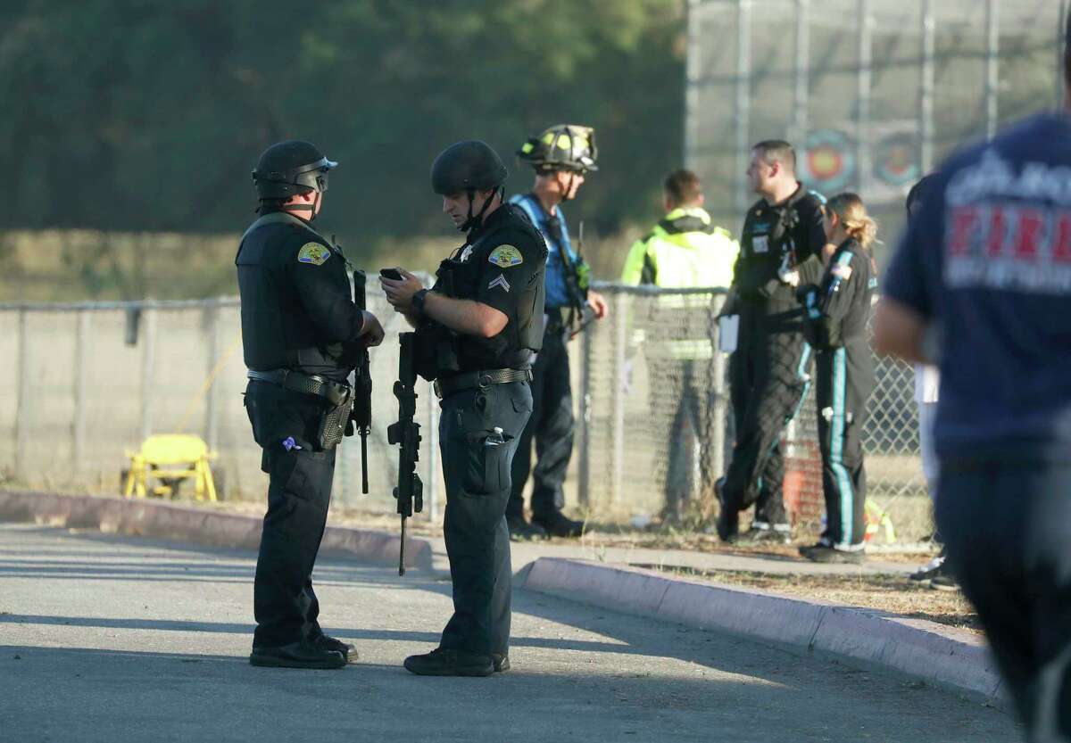Emergency personnel stand outside Gilroy High School following a deadly shooting at the Gilroy Garlic Festival in Gilroy, Calif., on Sunday, July 28, 2019. (Nhat V. Meyer/San Jose Mercury News via AP)