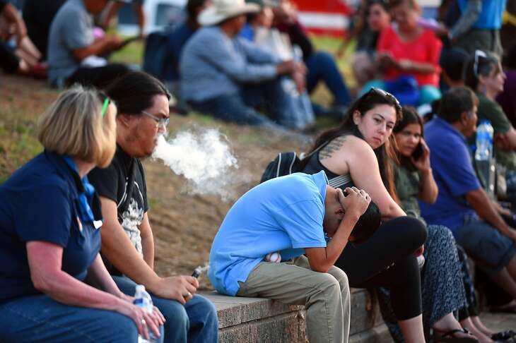 Attendees react at the scene of a shooting during the Gilroy Garlic Festival along Miller Avenue near Gilroy High School on July 28, 2019 in Gilroy, CA.