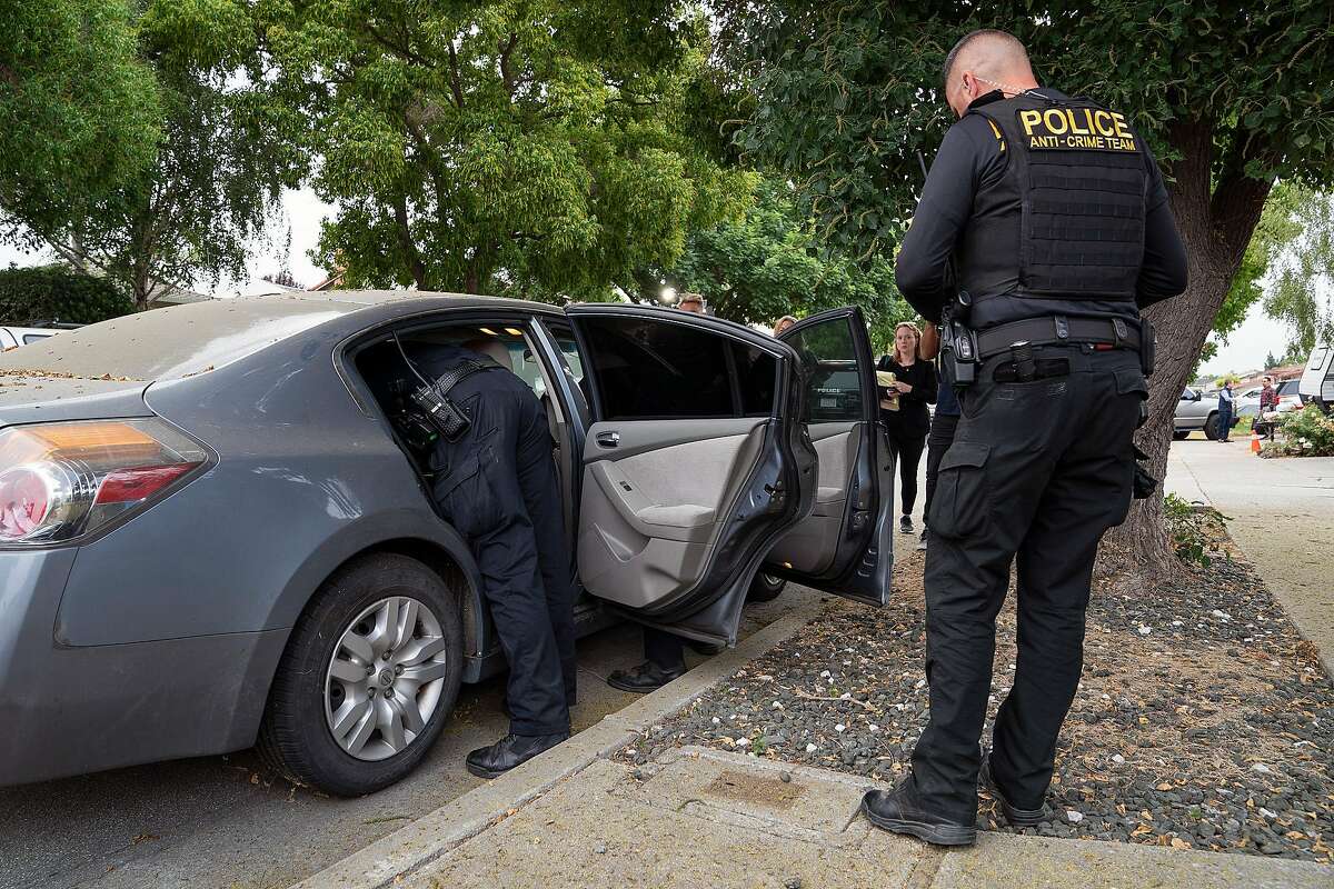 Gilroy Police Department officers search a gray Nissan Altima parked outside the Gilroy Garlic Festival shooting suspect Santino William Legan's family home in Gilroy, Calif., on Monday, July 29, 2019.