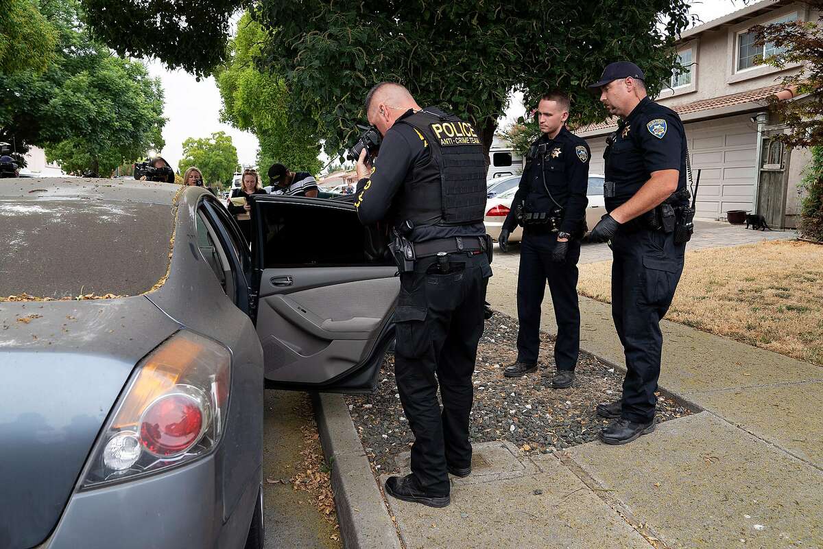 Gilroy Police Department officers search a gray Nissan Altima parked outside the Gilroy Garlic Festival shooting suspect Santino William Legan's family home in Gilroy, Calif., on Monday, July 29, 2019.