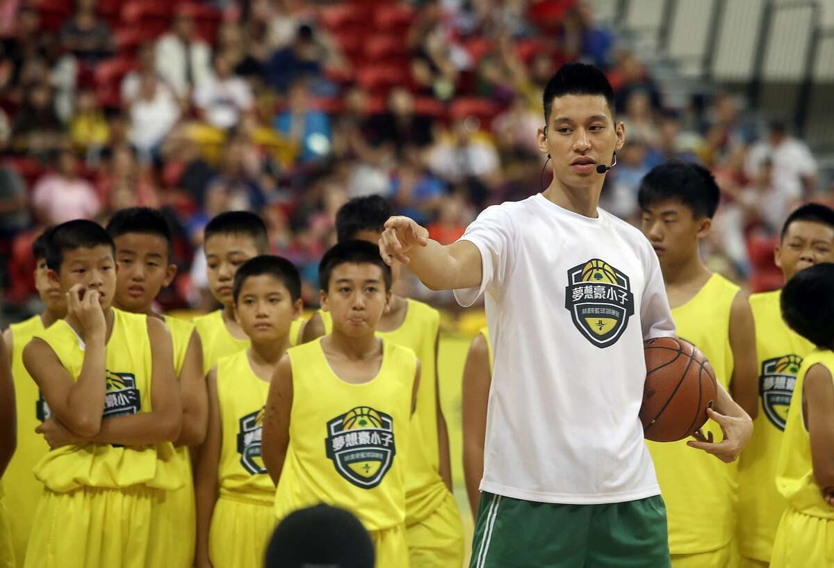 Former Toronto Raptors' Jeremy Lin, currently a free agent, talks to young Taiwanese players during a basketball clinic in Taipei, Taiwan, Saturday, July 27, 2019. Lin is in Taiwan to attend a charity event and basketball clinics for young athletes.