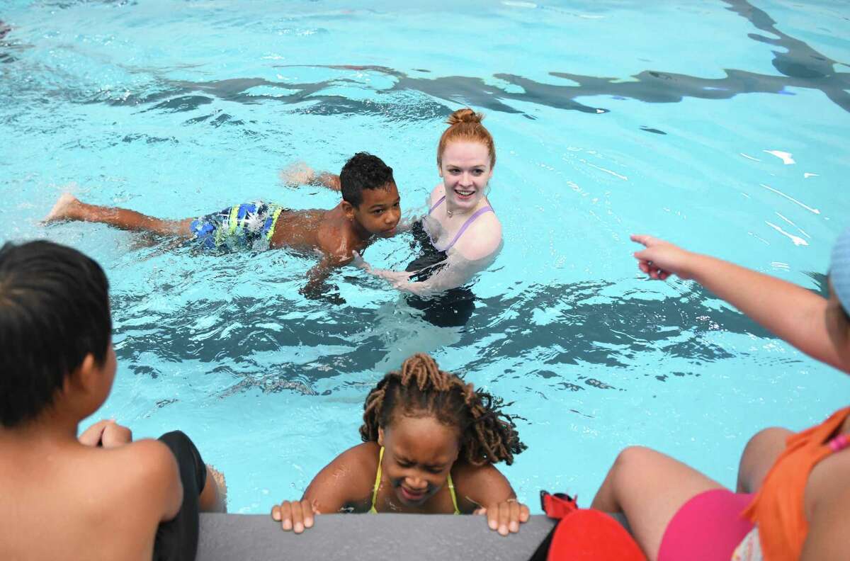 Stamford's Nolan Kinlock, 8, floats with swim instructor Kate Nusslein during the ZAC Foundation swim camp at the Boys & Girls Club of Stamford Yerwood Center in Stamford, Conn. Monday, July 29, 2019. More than 100 Stamford-area five- to nine-year-olds are participating in a four-day long water safety camp organized by The ZAC Foundation, which was established by Karen and Brian Cohn after the loss of their 6-year-old son Zachary Archer Cohn in a swimming accident in 2007. Nearly 15,000 other kids across the country have participated in ZAC camps that combine classroom instruction with swimming lessons and opportunities to learn important skills from first responders.