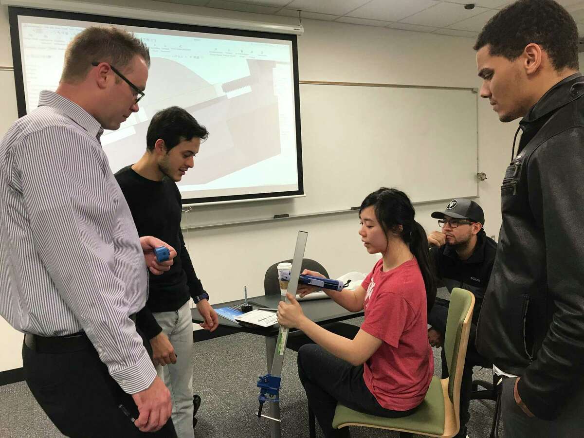 Justin Gallegos, Daniel Laverde, Fei Xie, Tripp Manzella and Andres Ledesma work on their prototype for the NASA Micro-G NExT challenge.