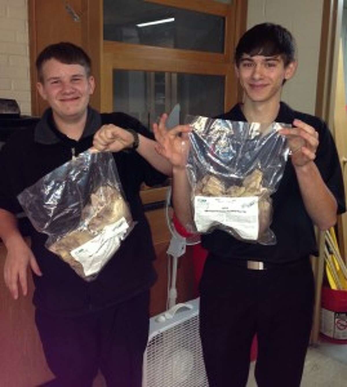Bear Lake Biology students Todd Merrill and Joeb Reed show the pig hearts they will be dissecting in class. Along with the hearts the grants also purchased scalpels and microscope slides along with much needed calculators.