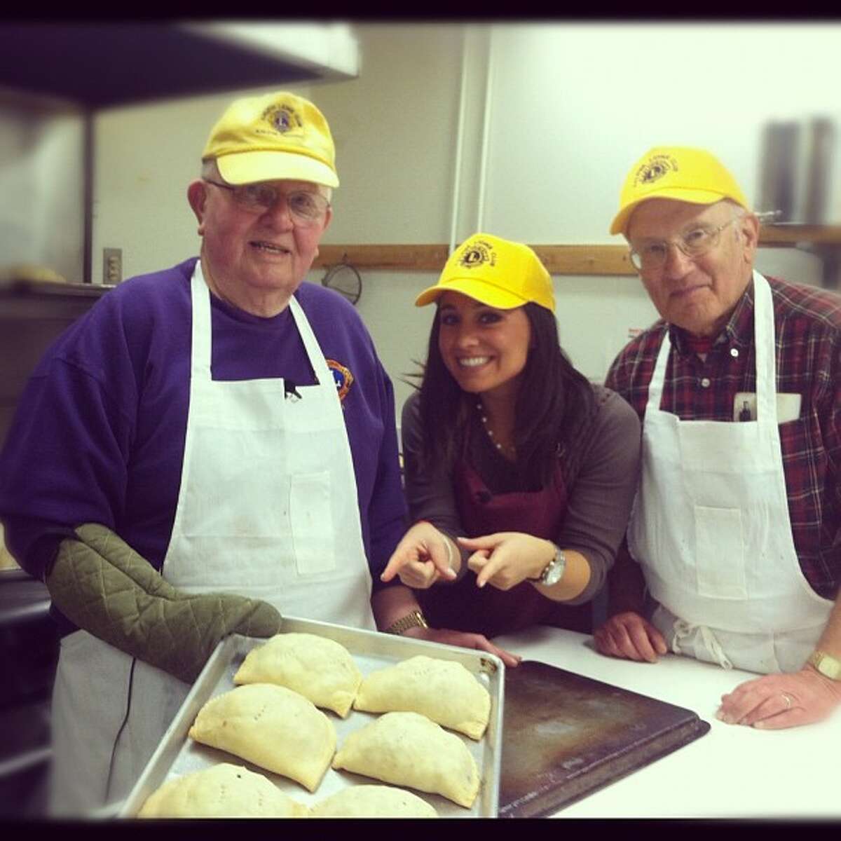 Ken Kuttilla (left) and John Makinen of the Kaleva Lions Club were recently honored as recipients of Lions International’s Melvin Jones Fellowship Award. Here’ they’re seen making pasties, which the club sells, with 9&10 News reporter Alex Jokich. (Courtesy Photo)