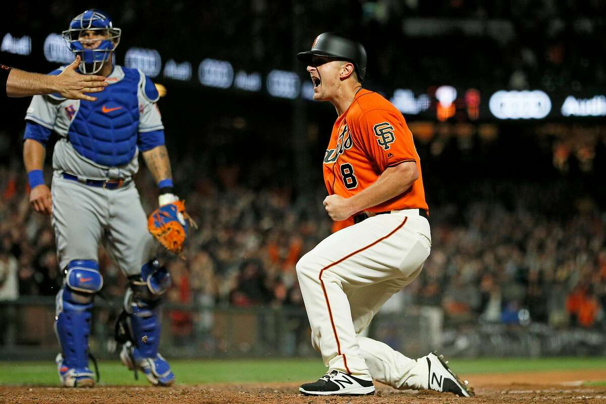 San Francisco Giants Alex Dickerson (8) reacts after sliding home to score in the 10th inning of an MLB game against the New York Mets at Oracle Park, Friday, July 19, 2019, in San Francisco, Calif. Giants Pablo Sandoval (48) reached on a fielding error by New York Mets Dominic Smith (22). Dickerson scored on the play to end the game 1-0.