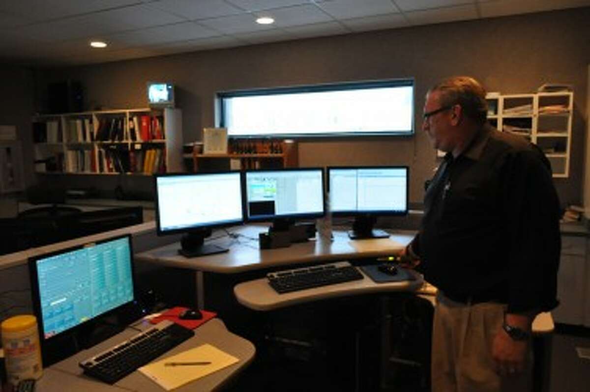 FILE - Manistee County Central Dispatch director Jim Espvik describes the equipment used on the job during an interview in 2013.