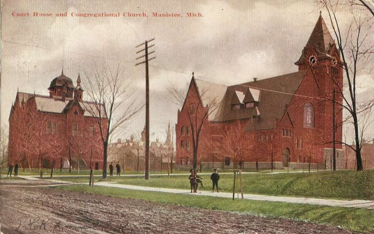 The First Congregational Church and Manistee County Courthouse building are shown in this photograph from the late 1890s.