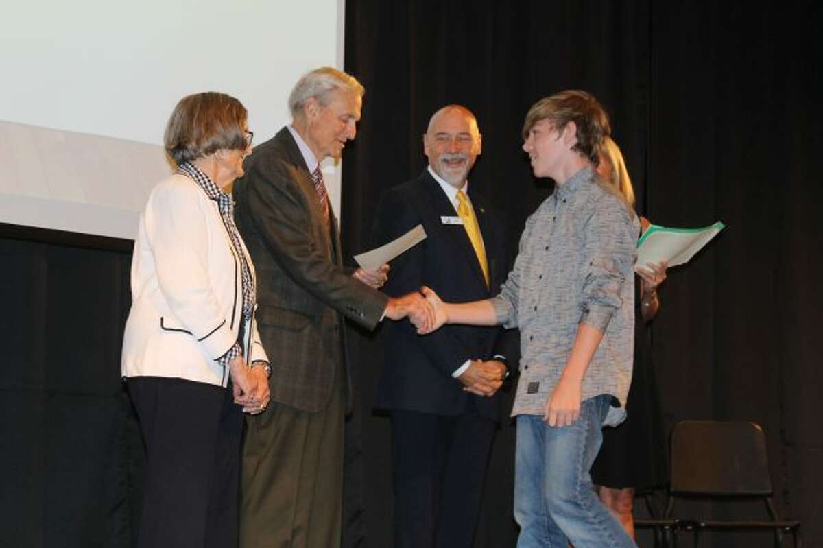 Bill and Marty Paine who are sponsoring the Manistee Commitment Scholarship program congratulate a student who is among the first class of 33 freshmen that are entering the program that could lead to a free college education from West Shore Community College.
