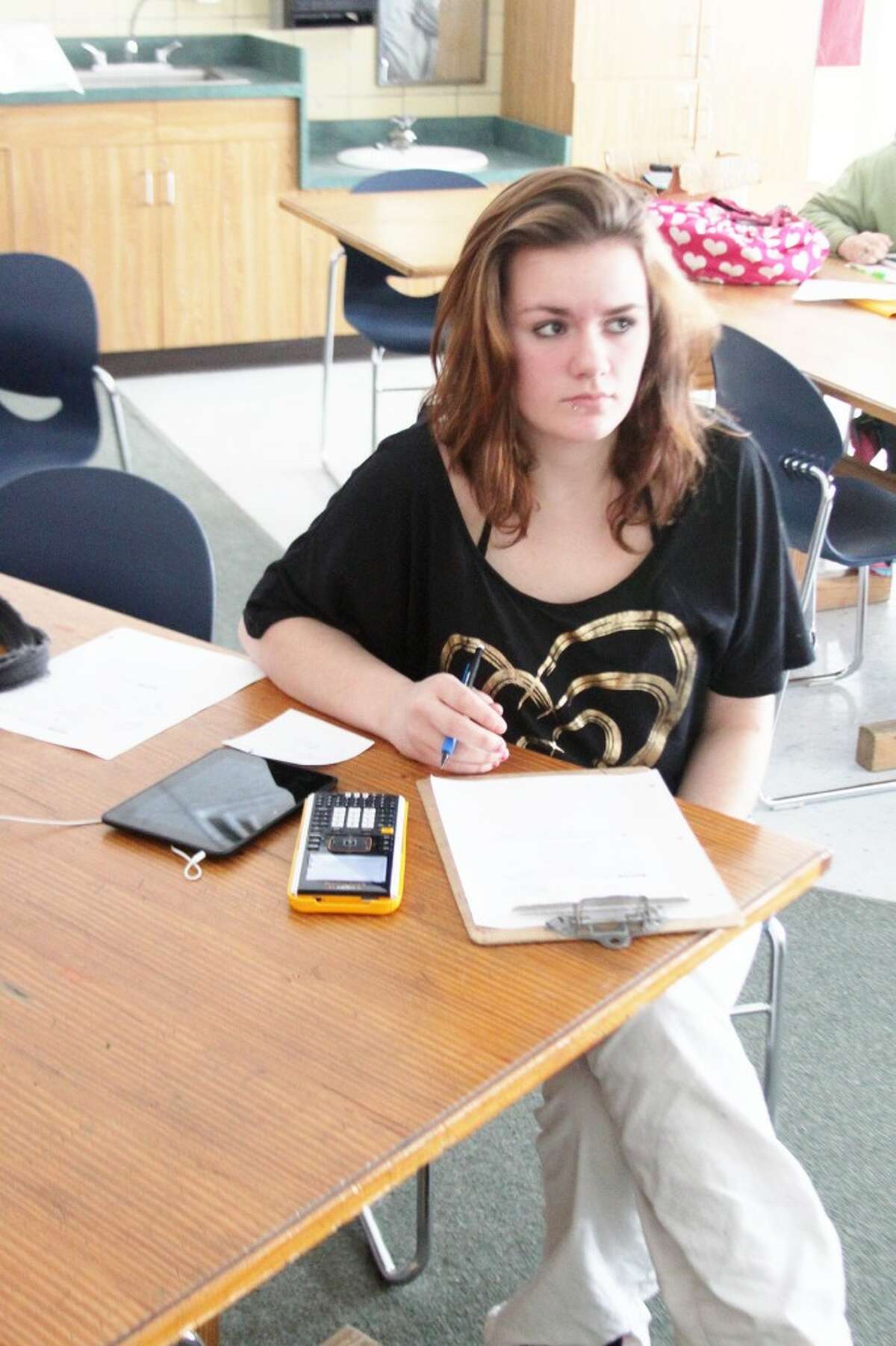 A CASMAN Academy math student is shown using one of the Texas Instrument calculators that are assisting students in their math studies.(Ken Grabowski/News Advocate)
