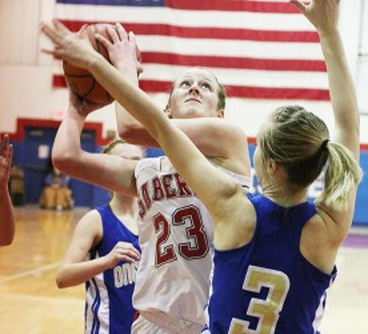 Manistee Catholic Central’s Haley Doyle (23) shoots over Onekama’s Kelly Koon during Thursday’s game. (Dylan Savela/News Advocate)