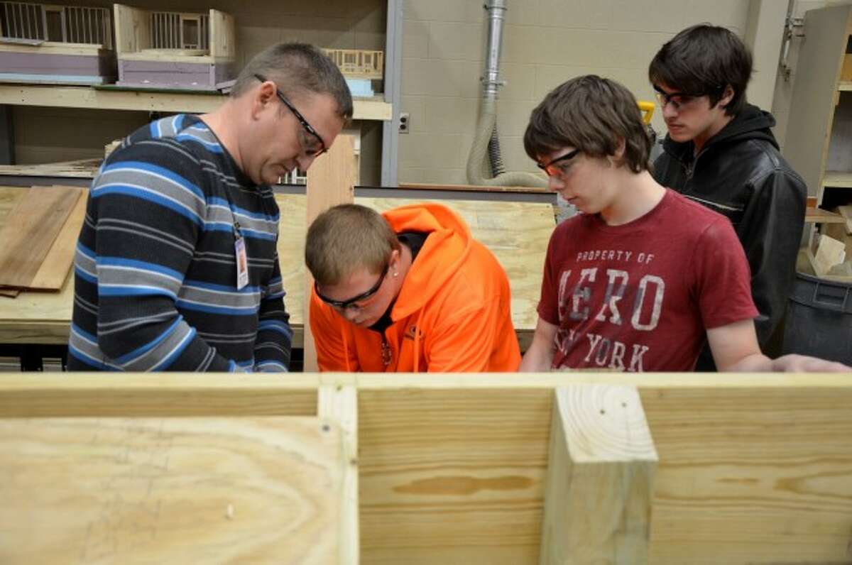 Left to right, Cadillac Technical Center applied construction technology instructor Brad VanBuren works with high school students Cody Scott of Cadillac, Marvin Dougherty of Bear Lake and Dwight Schneider of Brethren.