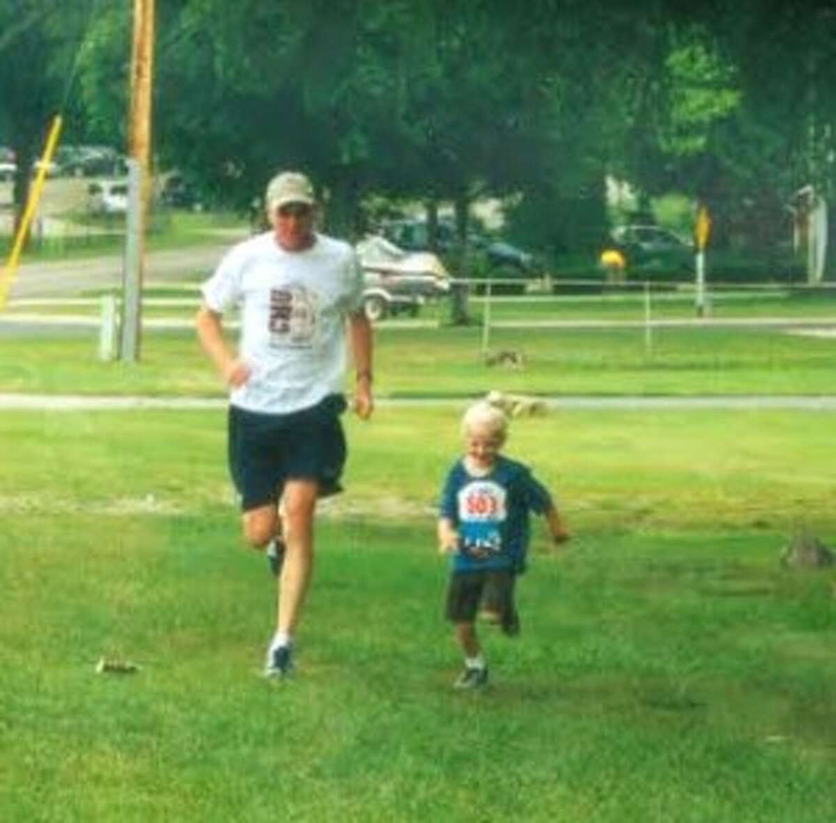 Annie, age 5 or 6, running with her dad.