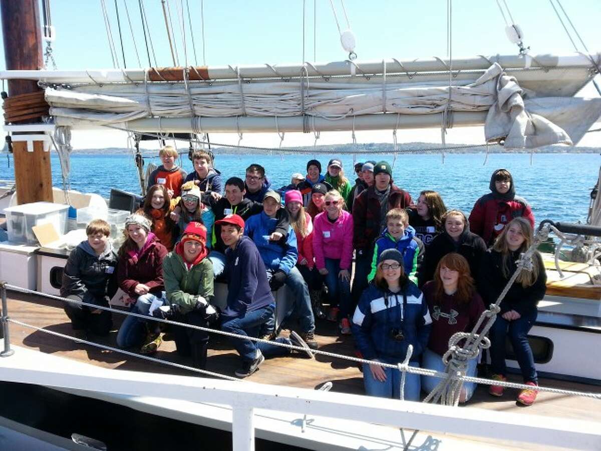 Members of the Bear Lake eighth grade science class of John Prokes pose aboard the tall ship Inland Seas. The students when on the ship as part of their science studies.