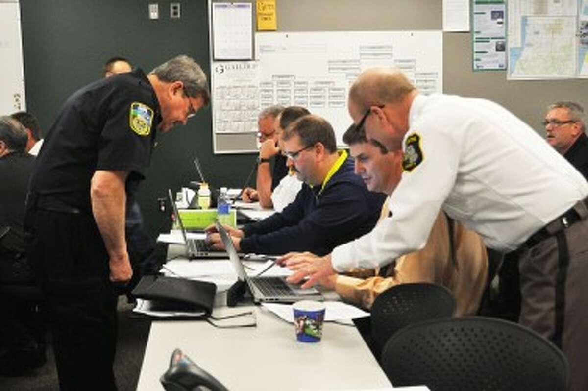 Manistee County Sheriff Dale Kowalkowski (right) works with undersheriff John O’Hagan to enter data into the Web emergency operations center during a drill on Thursday. The drill simulated an eight-month-long flu outbreak and was conducted at the Manistee County Sheriff’s Office.
