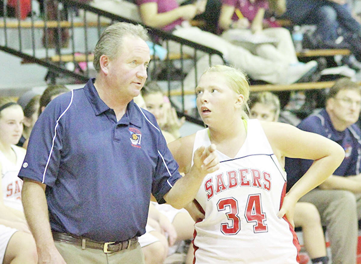 Longtime Manistee Catholic Central coach Todd Erickson, seen here giving directions to guard Alysha Heck during the 2012-13 season, turned in his resignation this week. He served as the MCC varsity girls head basketball coach for 21 years then held the same position at Manistee High School the last two seasons.
