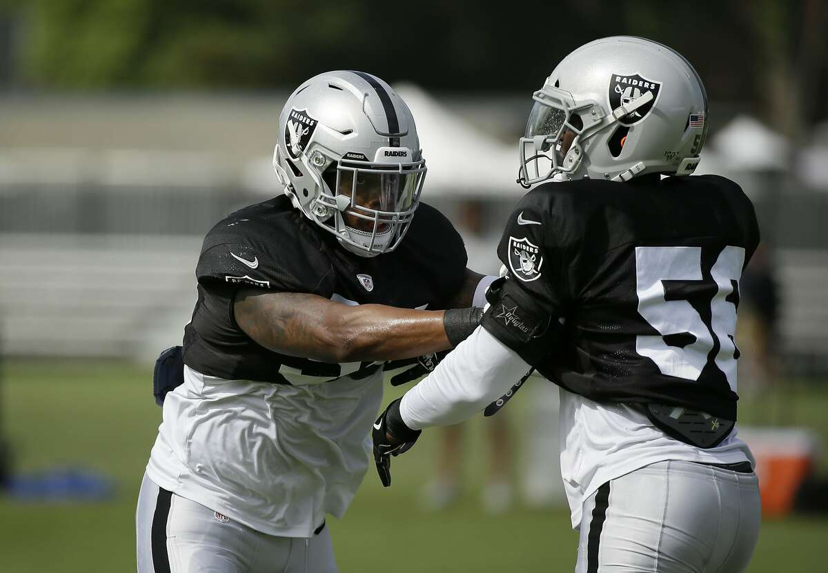 Oakland Raiders linebackers Brandon Marshall, left, and Oakland Raiders Te'Von Coney take part in drill during NFL football training camp Monday, July 29, 2019, in Napa, Calif. (AP Photo/Eric Risberg)