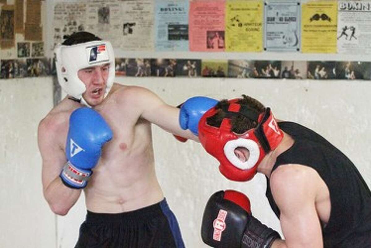 Tyler Bussell (left) spars with Muskegon’s Randy Patino on Sunday morning at the Manistee Boxing Club. Bussell is preparing for the Golden Gloves National Tournament of Champions. (Matt Wenzel/News Advocate)