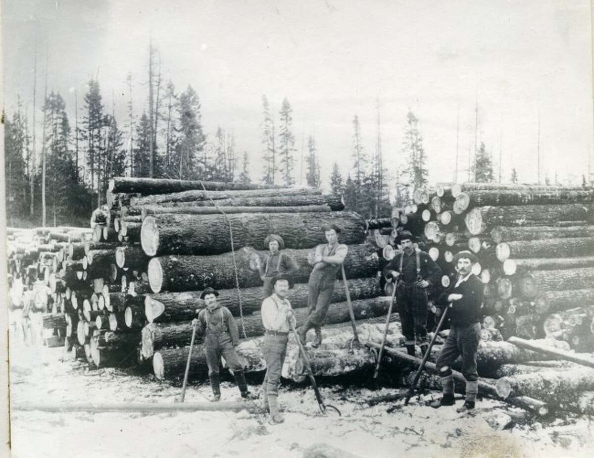 This group of lumberjacks prepare another load of logs to ship to the sawmill in this 1890 photograph.
