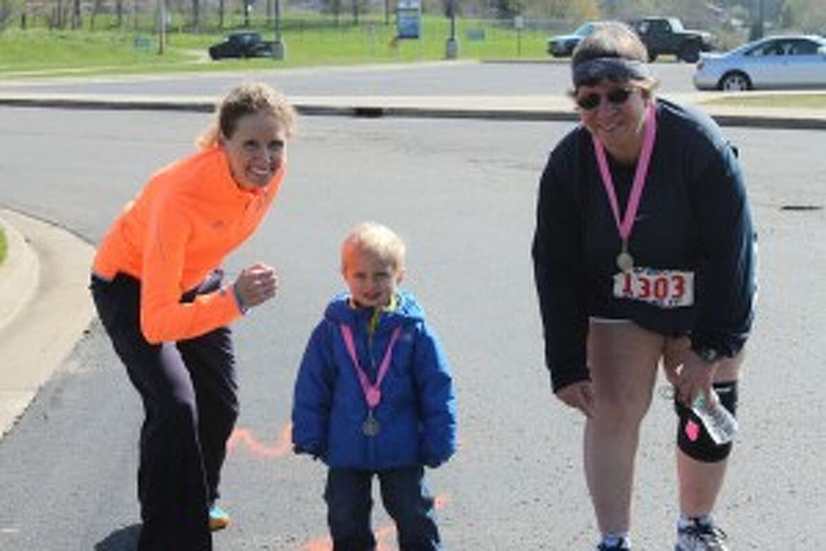 H.A.M. It Up founder Christa Johnson poses at the starting line with son Alec Johnson, 3, and Girls on the Run coordinator Lisa Fragomeli at Saturday's Girls on the Run event.