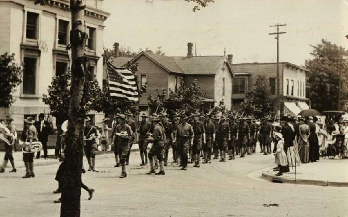 This picture shows an early 1900 Fourth of July Parade that was moving down First Street.