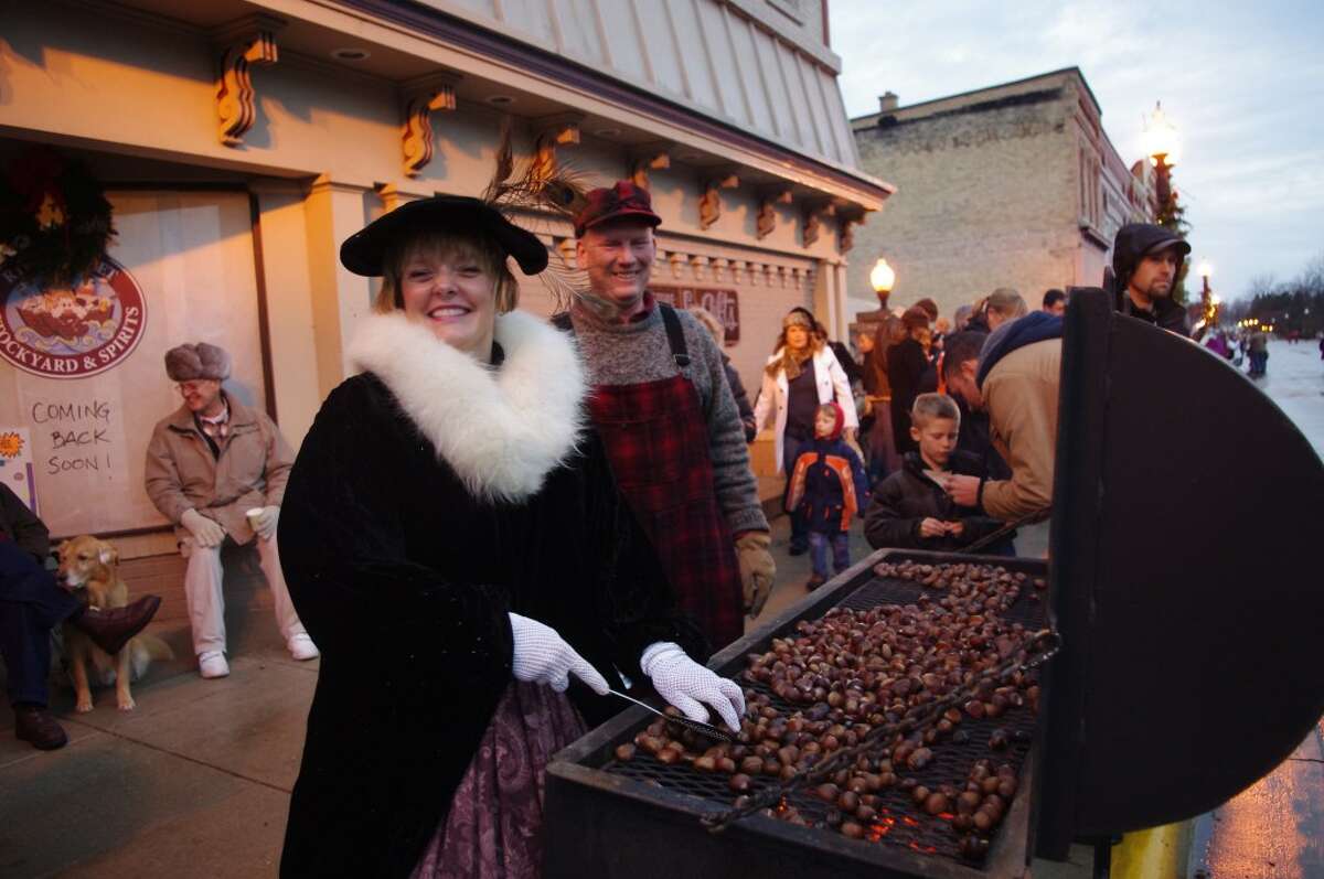 Kendra and Mike Thompson serve chestnuts before the 2011 Victorian Sleighbell Parade in Manistee. Kendra Thompson’s firm, Kendra Thompson Architects, has sponsored the chestnut roasting since 1990. 