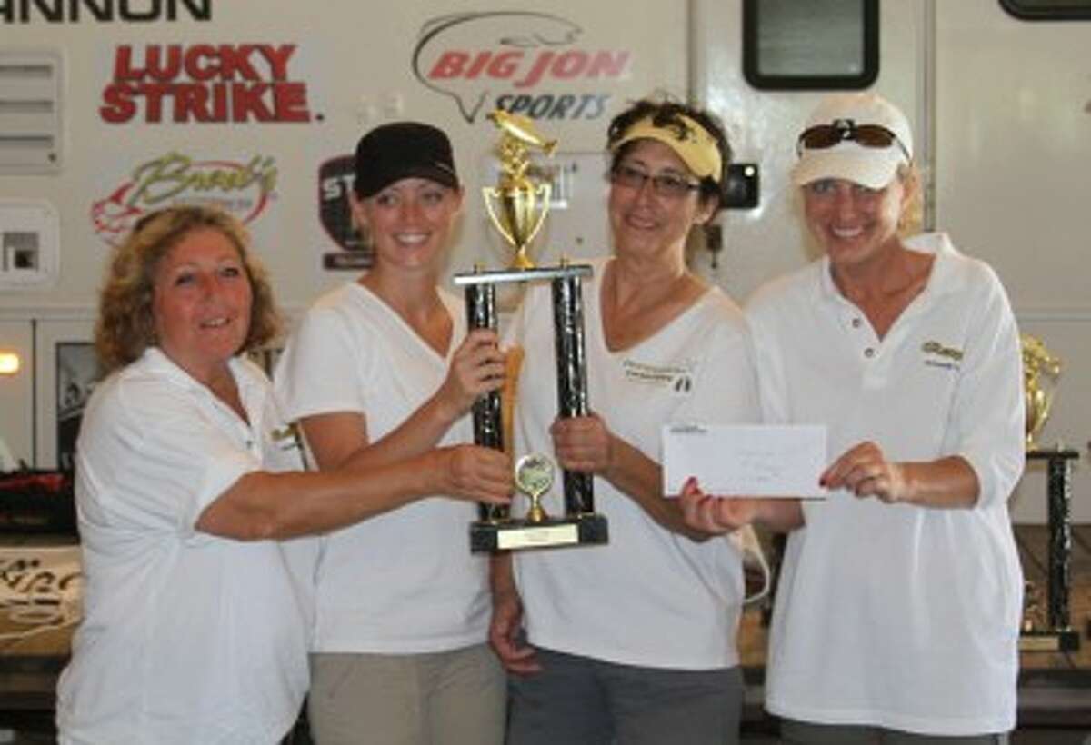 Renegade team members (from left to right) Toni Del Greco, Kristen Nowak, Julie Dixon and Trina Carlson pose with their trophy and $1,000 prize. (Matt Wenzel/News Advocate)
