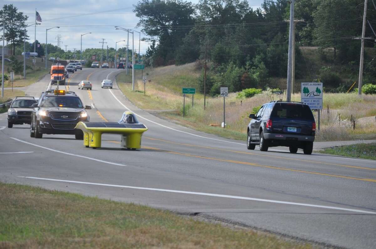 The University of Michigan solar car silently rolled through Manistee on U.S. 31 Tuesday, on its way around Michigan in a test run before it competes in the World Solar Challenge in Australia in October. (Eric Sagonowsky/News Advocate)