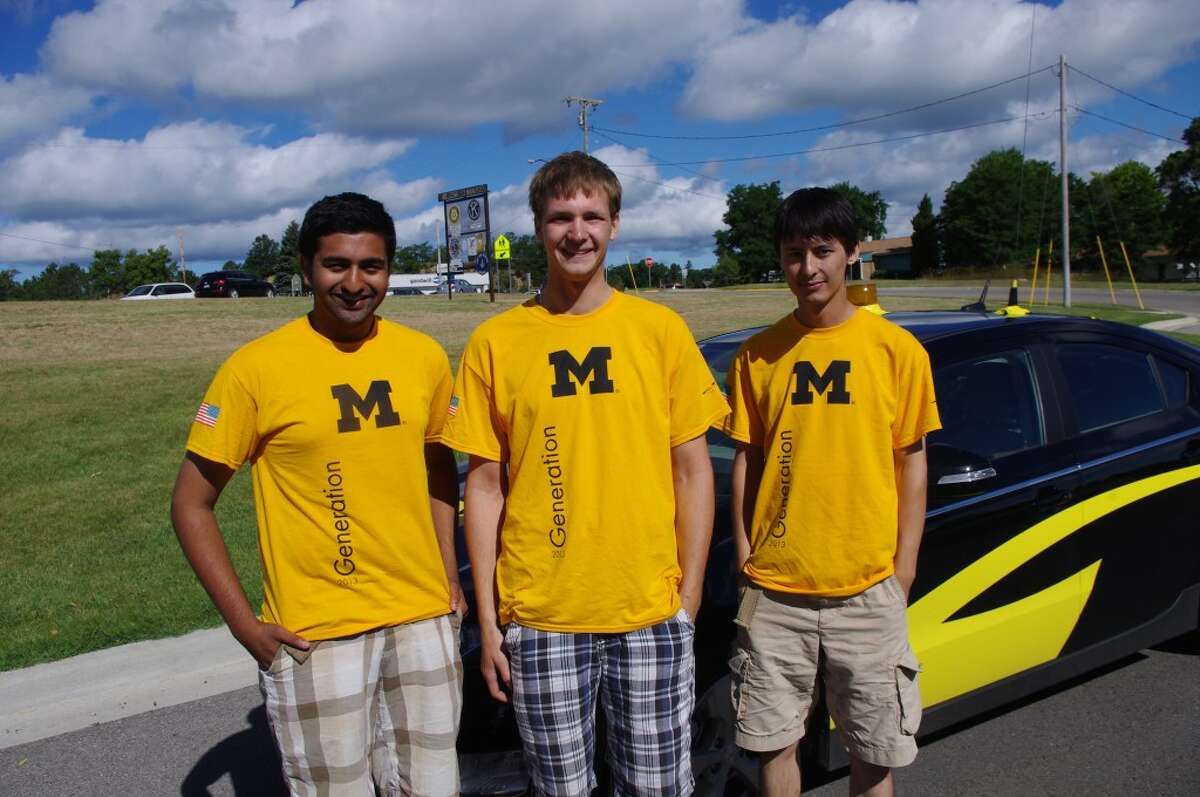 Three of the 21 members of the team escorting the University of Michigan's solar car are (from left to right) Pavan Naik, Duane Achterhof and Ryder Liu. Naik is a University of Michigan sophomore while Achterhof and Liu are seniors. The solar car is on a 1,200 mile trip around Michigan to prepare for the World Solar Challenge in Australia in October. (Dave Yarnell/News Advocate)
