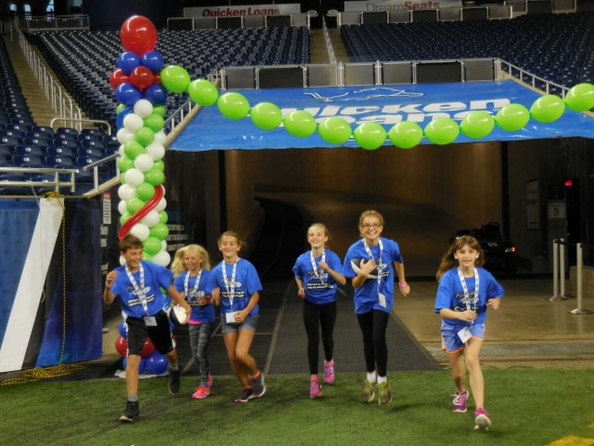 Running out of the tunnel at Ford Field in Detroit Bryce Harless, Chloe McPherson, Abby Pruyne, Randi Nelson, Courtney Haag and Victoria Hall. The students took part in the Fuel Up to Play 60 event.
