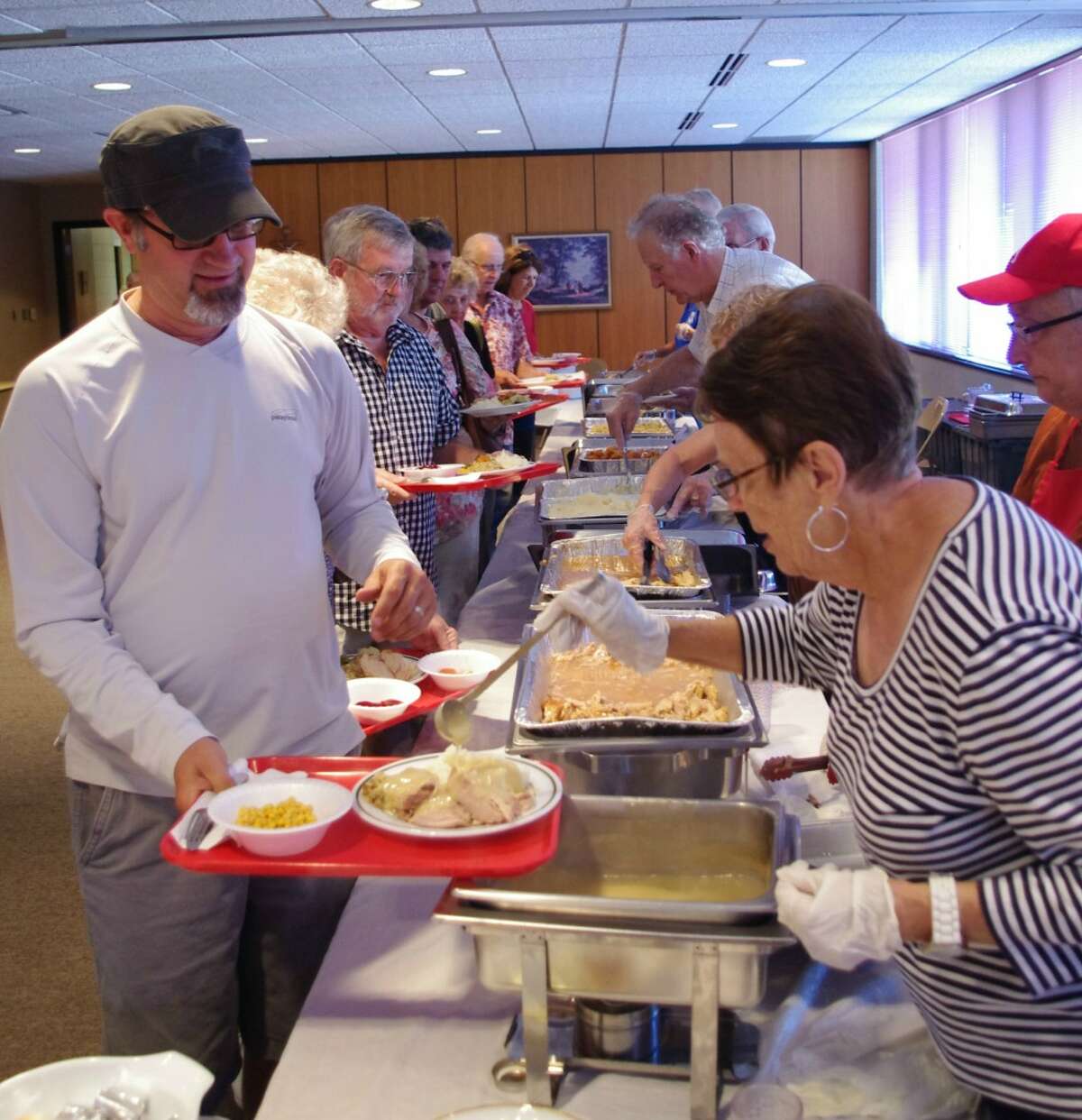 Keep the gravy coming, just like on Thanksgiving, Richard Morehouse said. Thanksgiving in July dinner was held Thursday at St. Joseph's Parish Center as a fundraiser for the Matthew 25:35 Food Pantry. (Dave Yarnell/News Advocate)