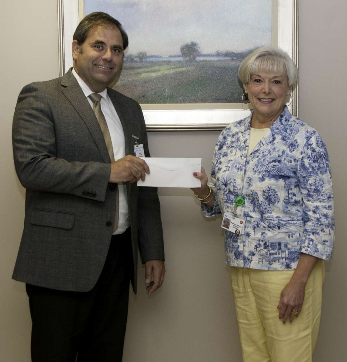 West Shore Medical Center Auxiliary president Kathleen Jeffreys presents West Shore Medical Center president James Barker with a check for $10,000, which is the first installment on the volunteer organization’s $50,000 pledge to support enhanced wound care services at the hospital. (Courtesy Photo)