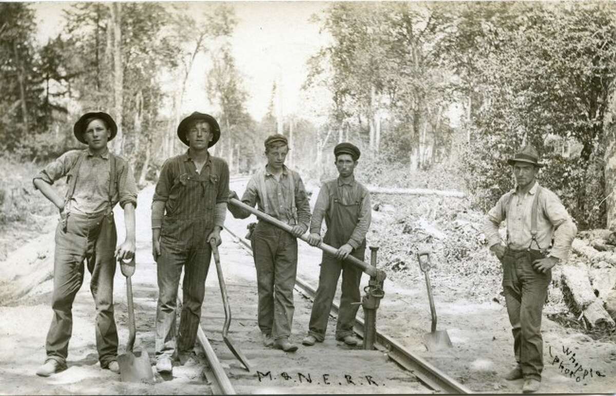 This section crew from the M&N.E. railroad is shown in this early 1900 picture repairing rail lines.