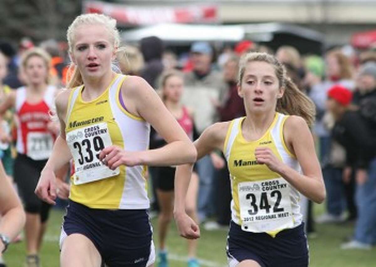 Manistee junior Annie Fuller (left) and sophomore Ashley Lindeman were both All-State runners last season while finishing in the top 15 at the Division 3 state finals. The duo leads a talented group of runners this season. (Matt Wenzel/News Advocate file photo)