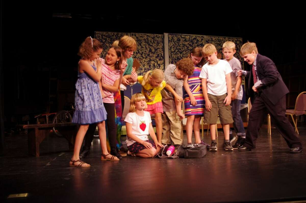 Ava Thuemmel (kneeling), who plays Jane, breaks the news to her classmates that her gym shorts have been stolen in the Manistee Civic Players children’s production of “The Dullsville Mystery,” that runs this weekend at the Ramsdell Theatre.