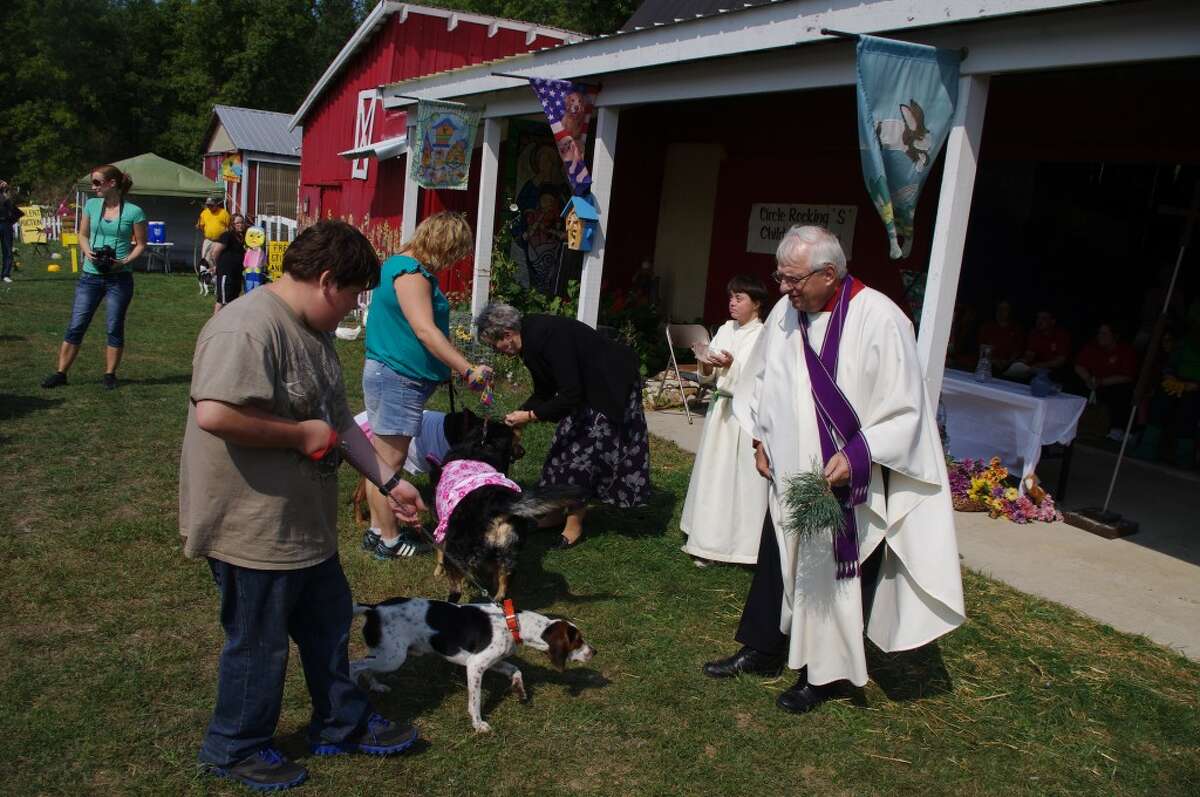 The Rev. David Selleck (right) of Manistee United Methodist Church was one of the ministers at last year's Blessing of the Animals and will also help with the program this year at Circle Rocking S Children's Farm. (News Advocate File Photo)
