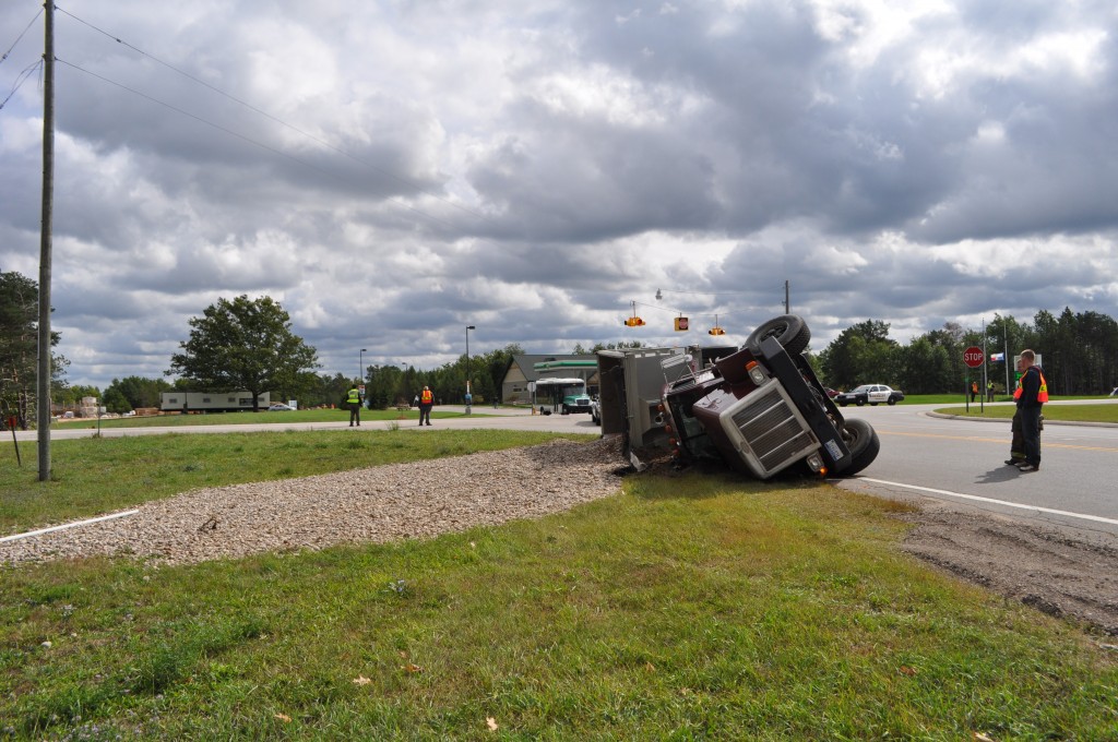 Truck flips over, no one injured seriously