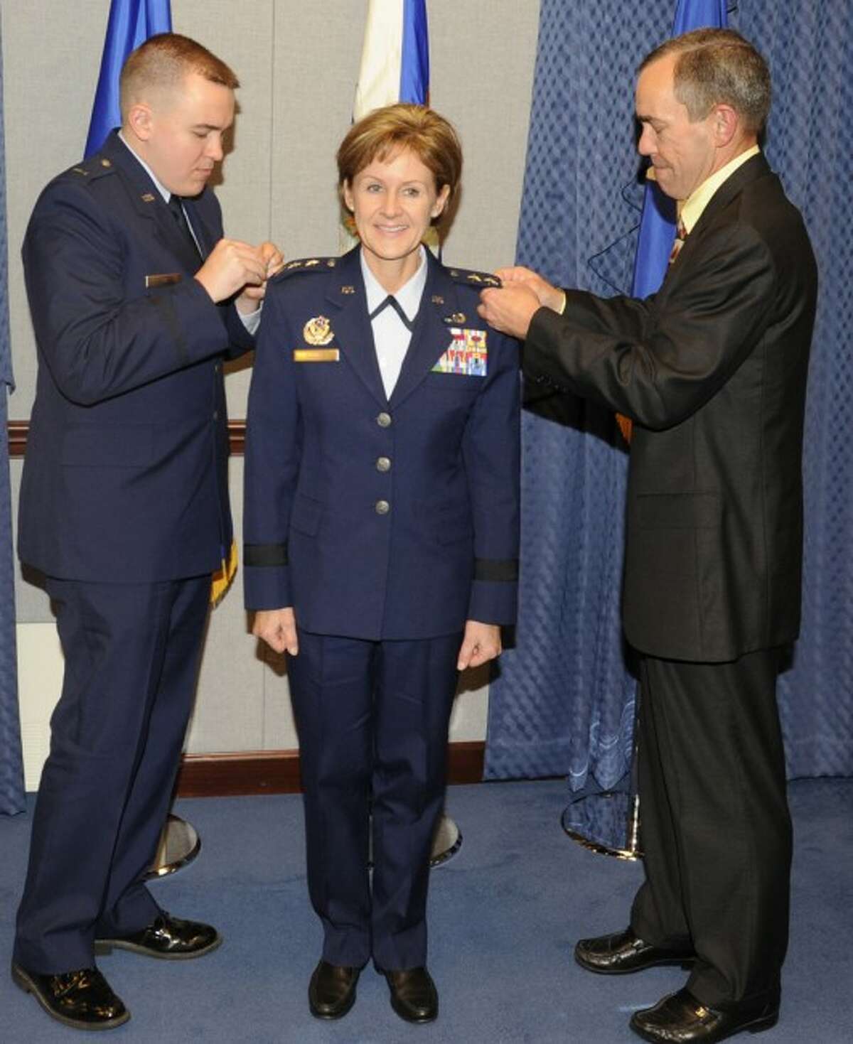 Air Force Lt. Gen. Judith Fedder is shown getting a new star pinned on her shoulders by her husband and son when she received a promotion to her current rank. Fedder was recently honored by Michigan State University with the Distinguished Alumni Award.
