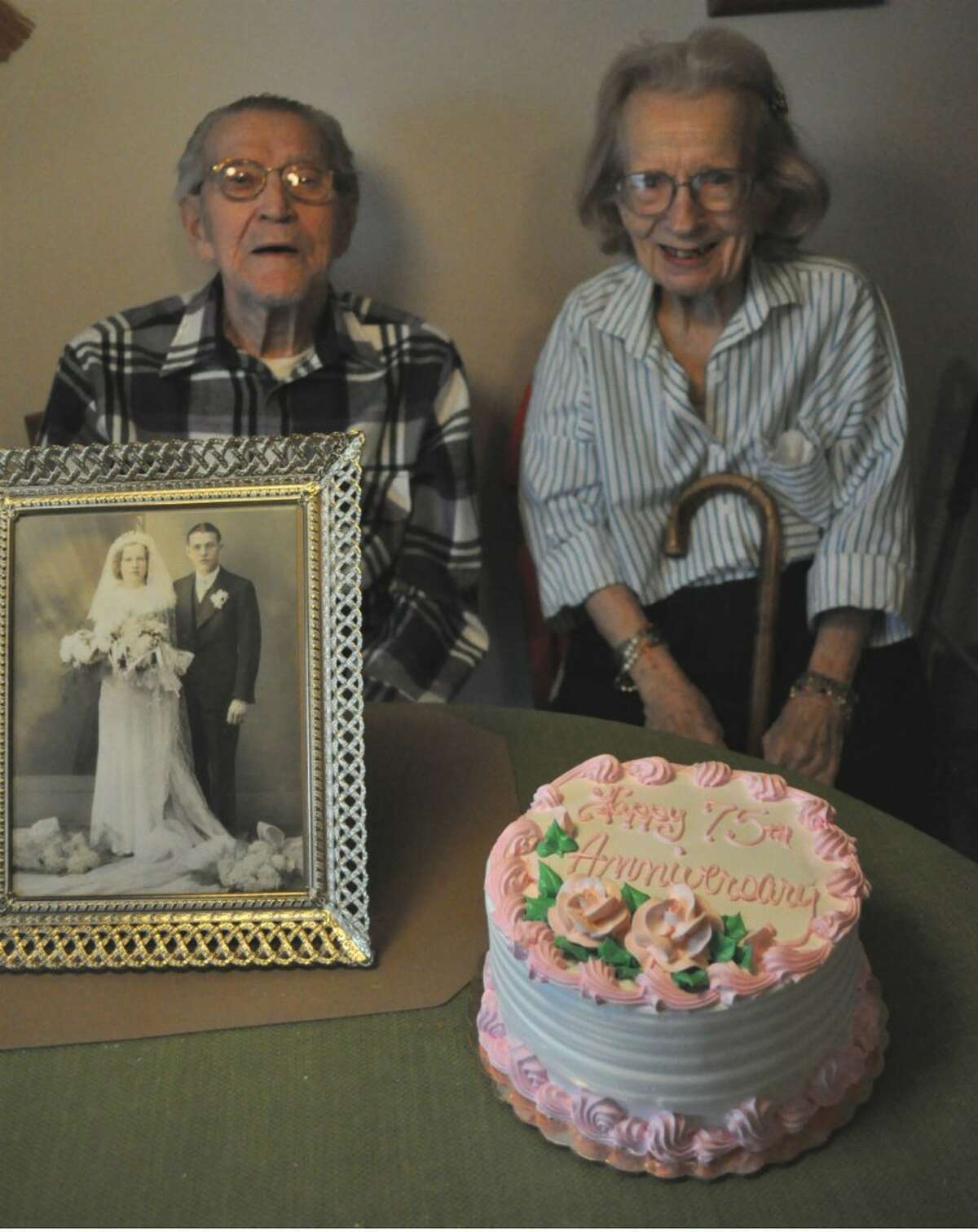 Joseph and Virginia Oleniczak celebrate their 75th wedding anniversary on Tuesday with a cake and their original wedding photo from 1937. Joe was 25 and Virginia was 23 when they married. They are now 100 and 98 respectively.
