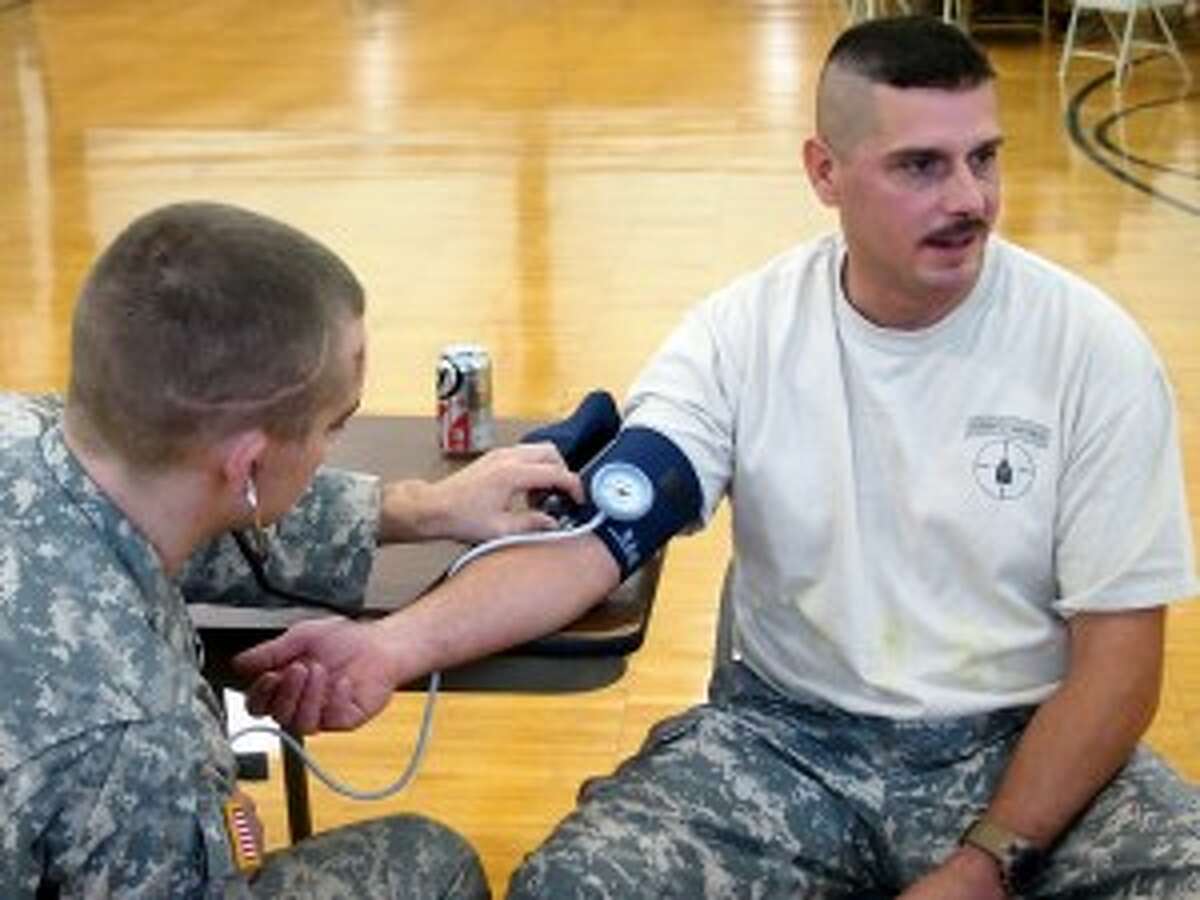 Sgt. 1st Class Darin Schultz, of Free Soil, has his blood pressure checked by a fellow soldier on Saturday during training at the Manistee National Guard Armory.