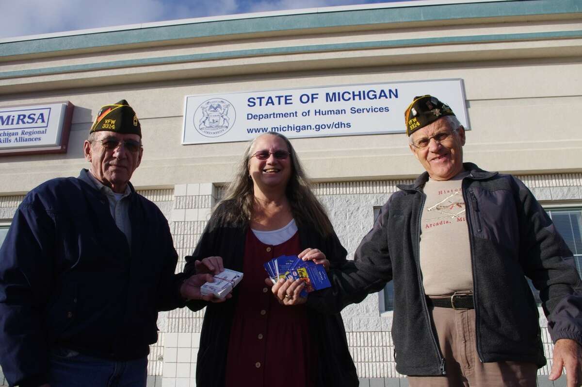 Officials from Arcadia VFW Post 3314 -- Norman McCarry (left), commander, and Keith McArthur, quartermaster -- recently presented $2,500 in grocery store gift certificates to Cosette Schaefer, community resource coordinator for the Department of Human Services for Benzie and Manistee counties. The certificates will be distributed by the Department of Human Services to veterans and their families in the two counties. (Dave Yarnell)