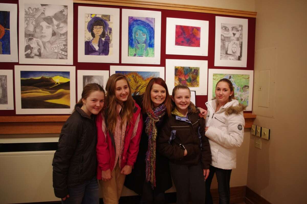 Onekama art teacher Dana Woolman (center) poses with her students, left to right, Emily Beeman, Madison Miller, Katie Beeman and Sophie Somerville. (Dave Yarnell/News Advocate)