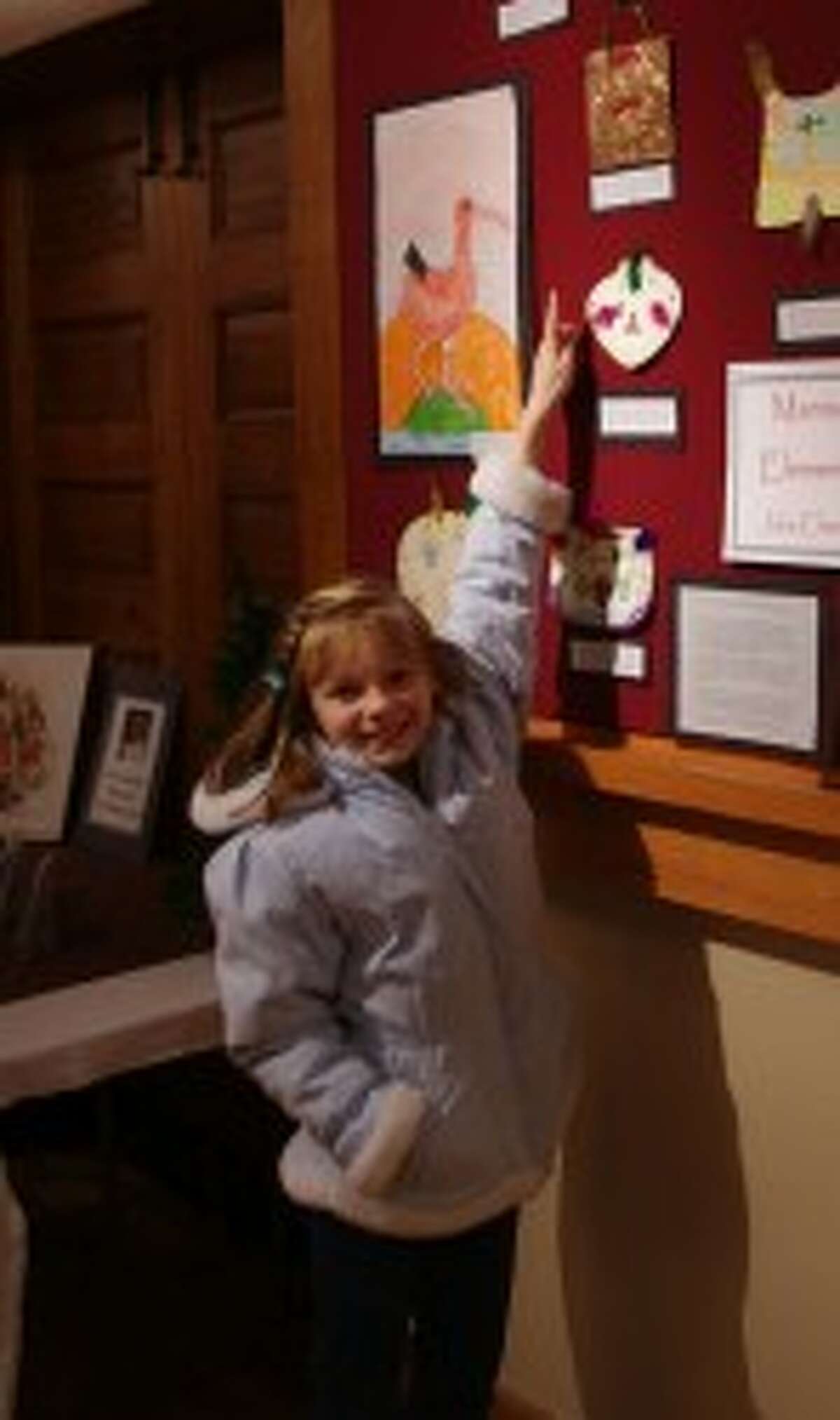 Kendahl Wright, a student at Manistee’s Kennedy Elementary School, points to her artwork. (Dave Yarnell/News Advocate)